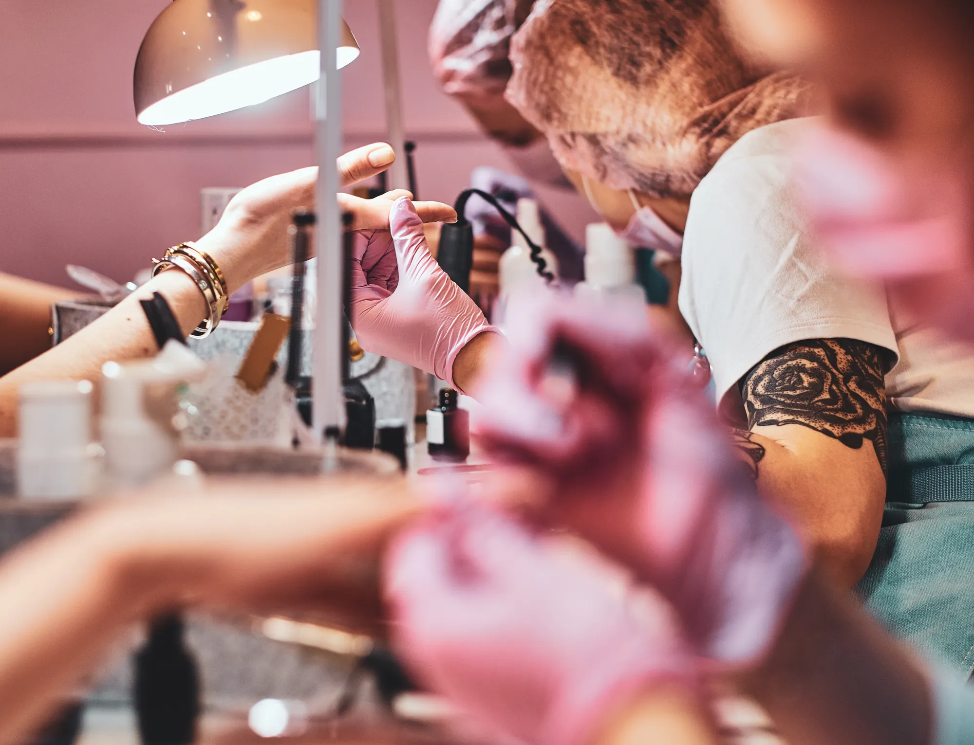 A nail technician working with a client