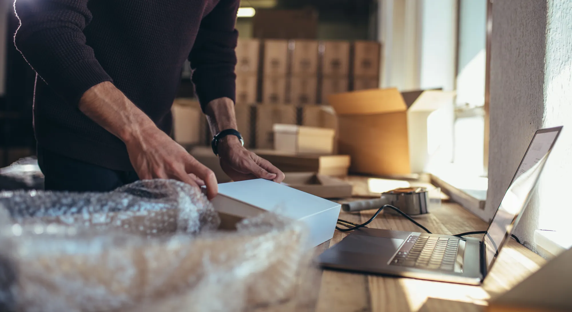 A small-business owner packing a shipment