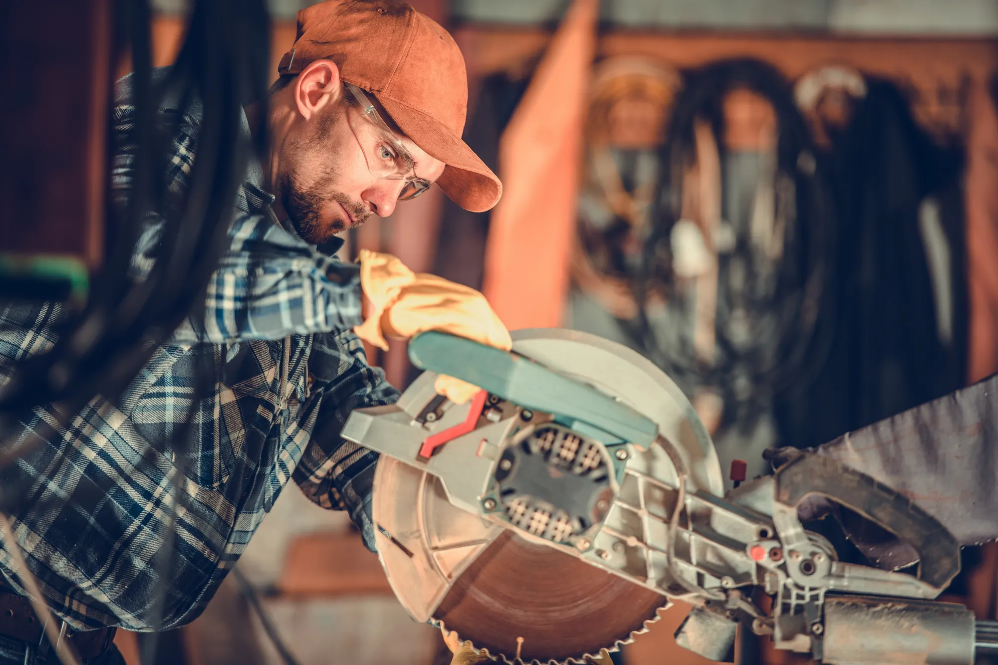 A craftsman cutting wood on a bench saw