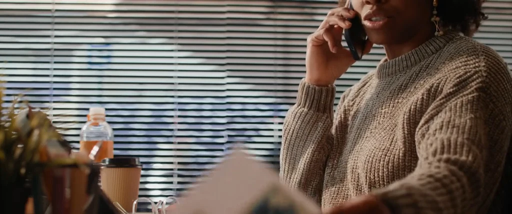 A business owner taking a call by the window